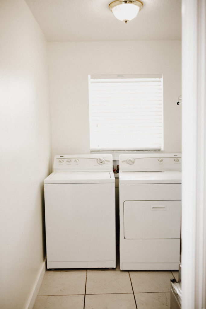 Bright and airy laundry room with bright new white washer and dryer at Fresh Life Recovery Homes in Bradenton Fl